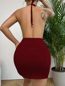 Detail of red backless mini dress showing tight fit and elastic knitted fabric texture