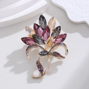 Detailed close-up of luxury crystal flower brooch with marquise stones and gold stem