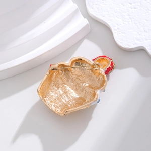 Macro view of Christmas brooch back featuring gold plating and secure safety pin fastener