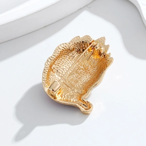 Golden clown brooch back view showing textured metal finish and secure pin fastener