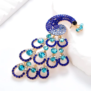 Detailed view of luxury vintage peacock brooch with blue crystals and sparkling rhinestones