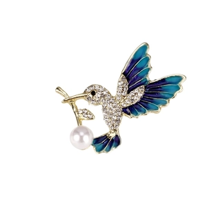 Elegant gold hummingbird brooch with purple enamel wings and a hanging white pearl