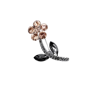 Elegant flower brooch with champagne crystals and silver alloy finish on white background