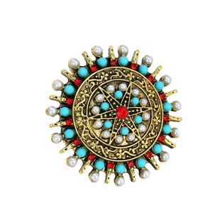 Bohemian vintage sunburst brooch with red gemstone, blue beads and pearls on gold metal