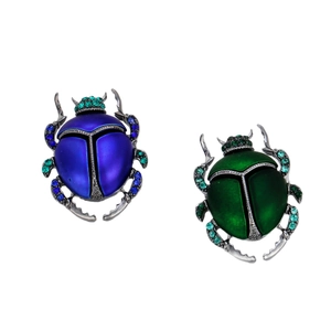 Vintage beetle insect brooches with rhinestones and enamel on a white background