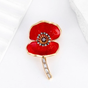 Poppy flower brooch with red enamel petals and gold plating on a white stone base