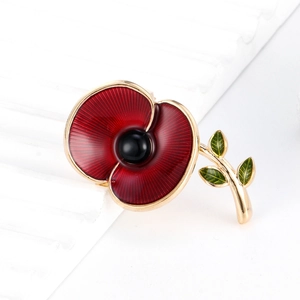 Poppy flower brooch with red enamel petals, green leaves and a gold metal finish