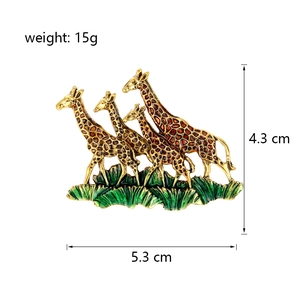 Fashionable gold giraffe brooch with brown enamel detailing and green grass accent