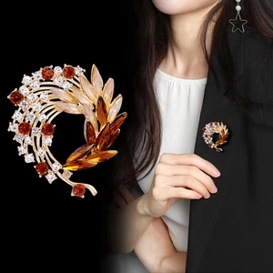 Elegant gold flower brooch with amber crystals and sparkling stones for suits and sweaters