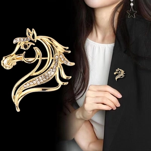 Vintage gold horse head brooch with white crystals on black blazer for men and women
