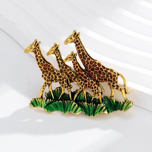 Detail of vintage giraffe brooch with enamel oil drip finish on white display stand