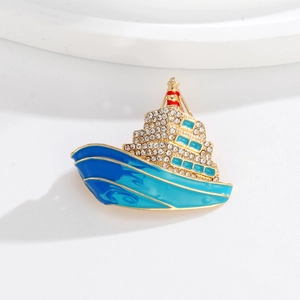 Exquisite gold cruise ship brooch with sparkling rhinestones and blue enamel details