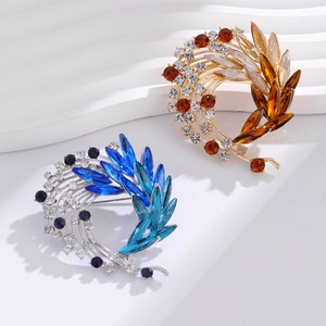 Elegant crystal leaf spiral brooch in blue and brown finishes for suits and sweaters