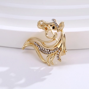 Macro detail of a golden rooster brooch with sparkling crystals and hollow metalwork