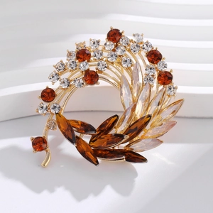 Macro detail of luxury floral crystal brooch with golden base and amber rhinestones