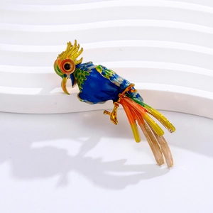 Detail of colorful parrot brooch with enamel drips and gold-tone branch setting