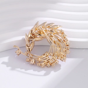 Detail of gold brooch showing grain ear shape with crystals and secure back pin closure