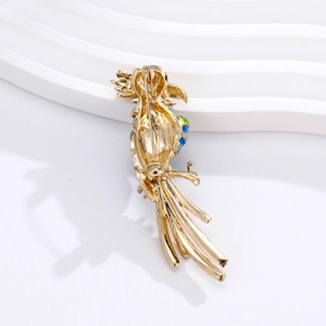 Back view of golden parrot brooch with colorful enamel wings and secure pin fastening