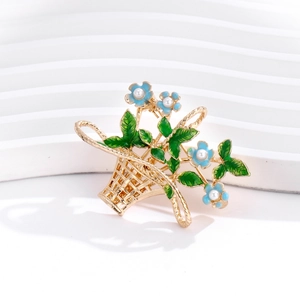 Elegant floral basket brooch with sky blue flowers, faux pearls, and green enamel finish