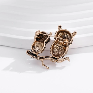 Back view of vintage gold owl brooch showing secure pin fastener and alloy texture