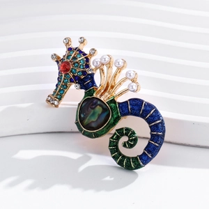 Detail of seahorse brooch with blue enamel inlay and white faux pearl accents