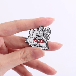 Macro shot of cartoon opossum enamel pin on mushroom with I'm at my limit text