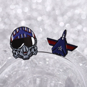 Cartoon pilot helmet and fighter jet enamel pin set in vibrant blue and red finish