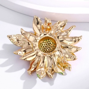 Broche tournesol dorée avec détail de fermoir de sécurité sur fond blanc