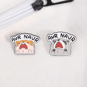 Detail of cute hamster and raccoon enamel pins with screaming expression on canvas bag