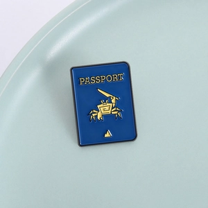 Blue passport enamel brooch with gold crab and sword design for bags and clothing
