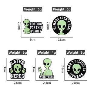 Set of five funny green alien enamel pins with humorous slogans for bags and jackets