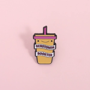 Cute cartoon yellow drink cup enamel pin featuring Serotonin Booster text and smile