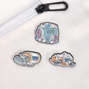 Close-up of cat and dog enamel pins on a white canvas bag showing serotonin booster theme