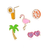 Detail view of colorful summer enamel pins set featuring flamingo and palm tree