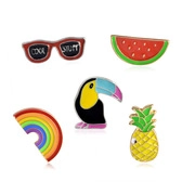 Detailed macro view of 5-piece set cartoon enamel pins with pineapple and rainbow designs