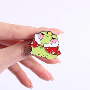 Cute green frog enamel pin set with a golden crown and red mushroom style cloak