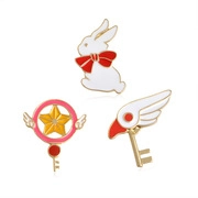 Three-piece enamel pins featuring cute rabbit and magical star wand motifs on golden base