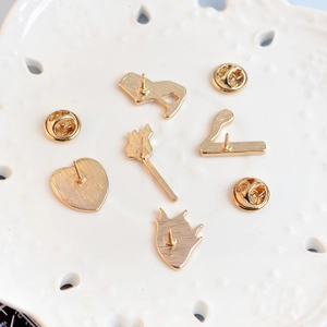 Set of five gold metal brooch backs with textured finish and butterfly clutches