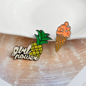 Dettaglio di spille in smalto con cono gelato arancione e design a forma di ananas Girl Power