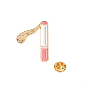 Detailed close-up of a cigarette enamel brooch with gold trim and butterfly clutch back
