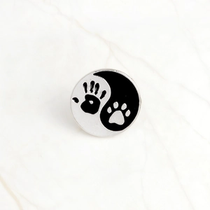 Yin Yang paw and handprint enamel pin badge in minimalist black and white design