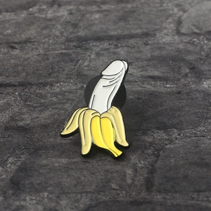 Detailed close-up of a creative banana shaped enamel pin with a unique peel-off design