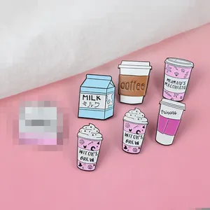 Detailed view of six cartoon milk and coffee enamel pins on a pink background