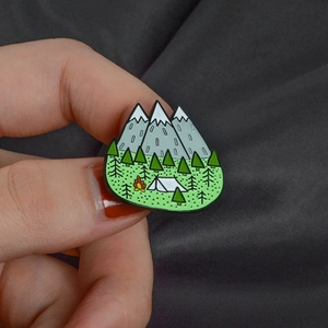 Enamel mountain peak brooch with snowy forest and white camping tent design
