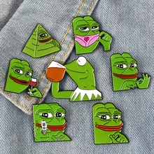 Detailed close-up of Pepe the Frog and Kermit enamel pin set on blue denim fabric