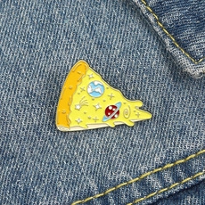 Detail showing the space-themed pizza enamel pin on a blue denim jacket texture