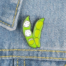 Detailed enamel pin with cute animals in a pea pod attached to blue denim jacket fabric