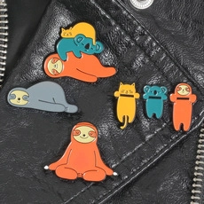 Detailed view of colorful enamel animal pins displayed on a black leather jacket