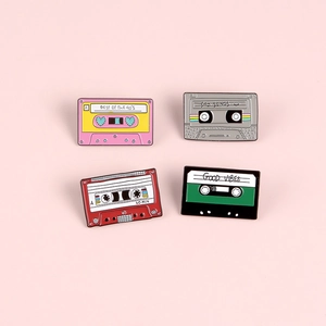 Vintage cassette tape enamel pin set featuring retro 90s designs on a pink background