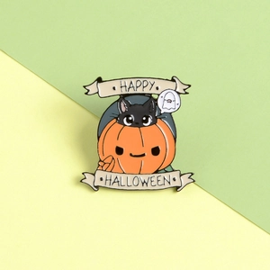 Detail of metal enamel pin with Happy Halloween pumpkin and black cat cartoon design